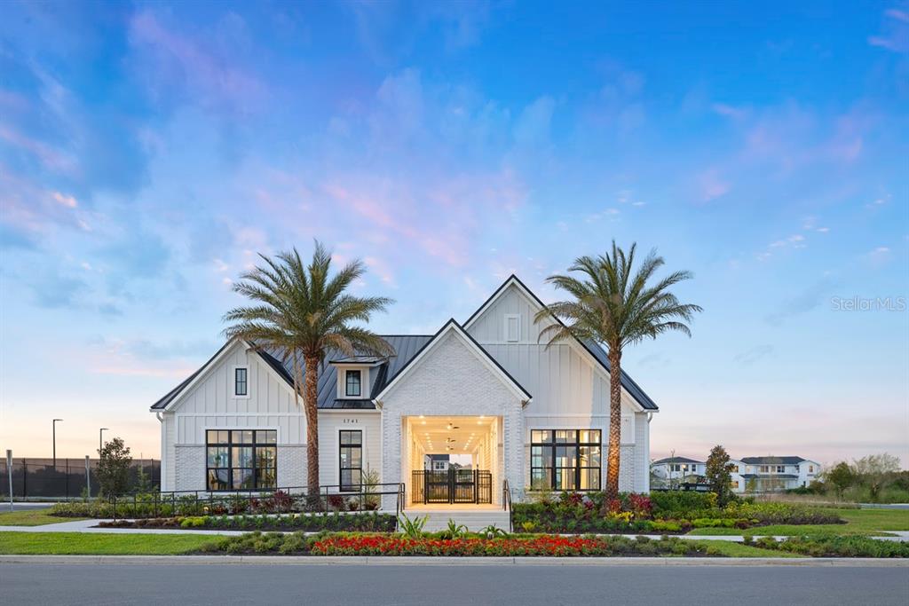 A modern white farmhouse-style building features a central covered breezeway and two palm trees — 1525 RIDGEBACK LANE, APOPKA, FL