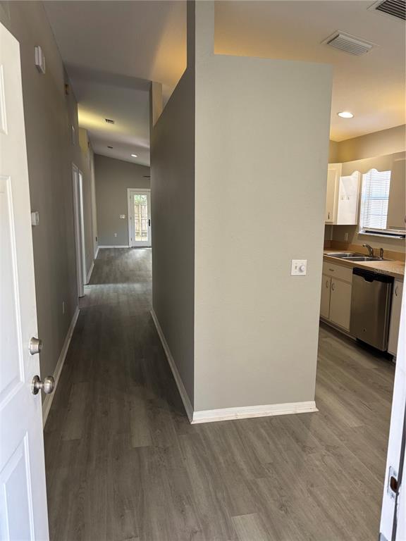 An entryway leads to a hallway with wood-look flooring and an adjacent kitchen area — 3906 NE 22ND STREET, OCALA, FL