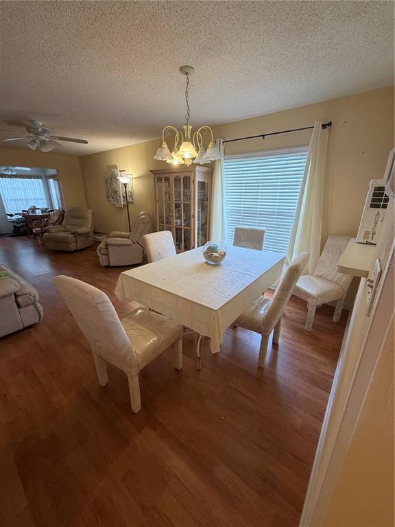 A dining area with a table, chairs, a chandelier, and a wooden hutch — 2400 WINDING CREEK BOULEVARD UNIT 18A-110, CLEARWATER, FL