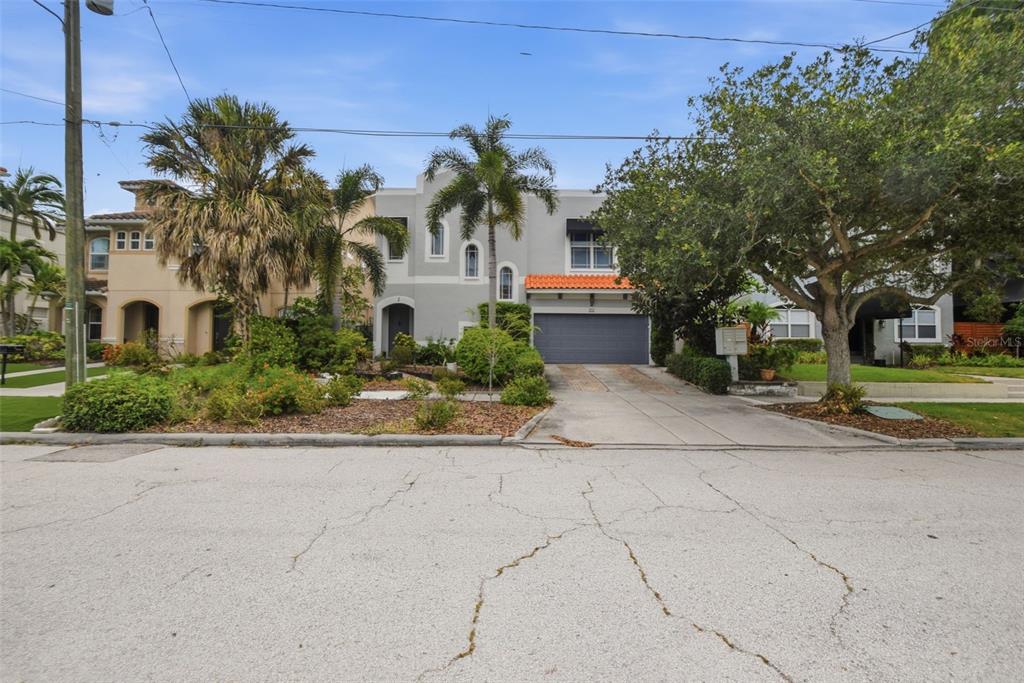 A two-story house with a gray exterior, a two-car garage, and a brick-paved driveway — 211 S WESTLAND AVENUE UNIT 1, TAMPA, FL