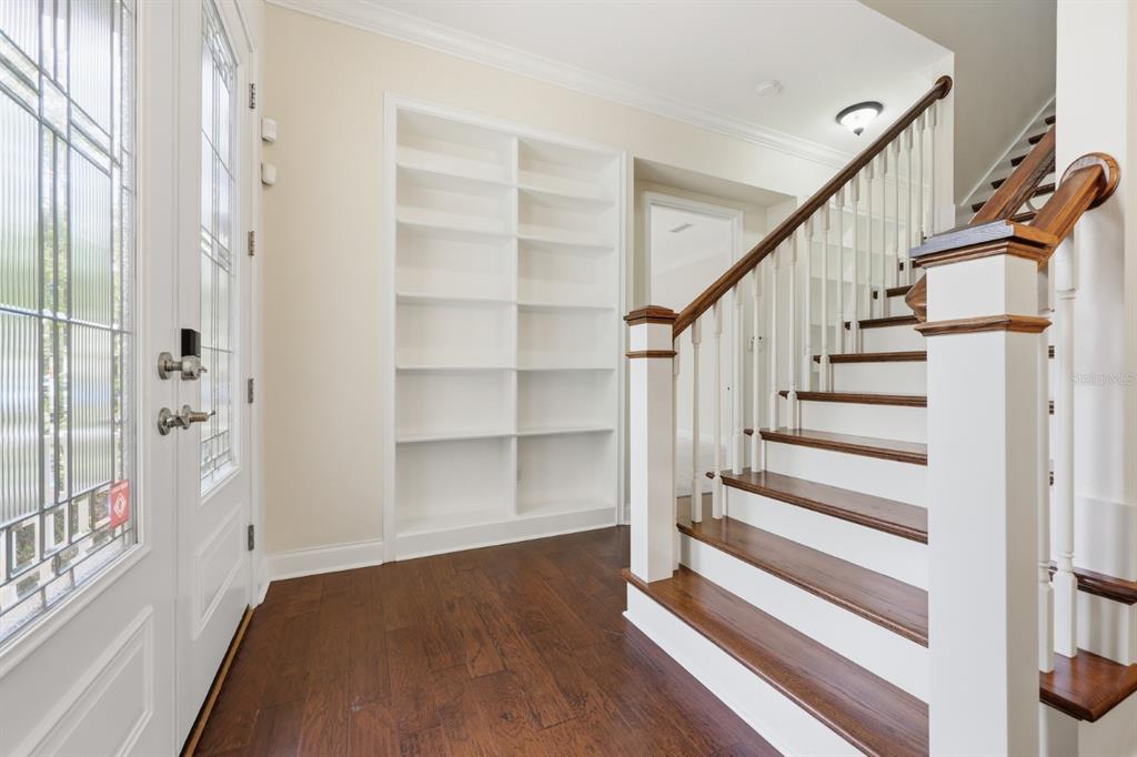 A covered front porch features white columns, a white railing, and tan paver flooring — 13265 SW 6TH AVENUE, NEWBERRY, FL