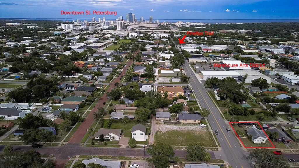 An aerial view shows a residential property highlighted in red near a city skyline — 2560 5TH AVENUE S, ST PETERSBURG, FL