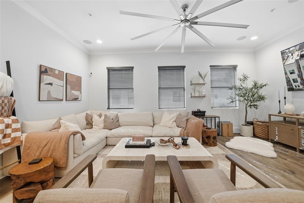 A living room features a large sectional sofa, two armchairs, and a central coffee table — 2511 N GRADY AVENUE UNIT 91, TAMPA, FL