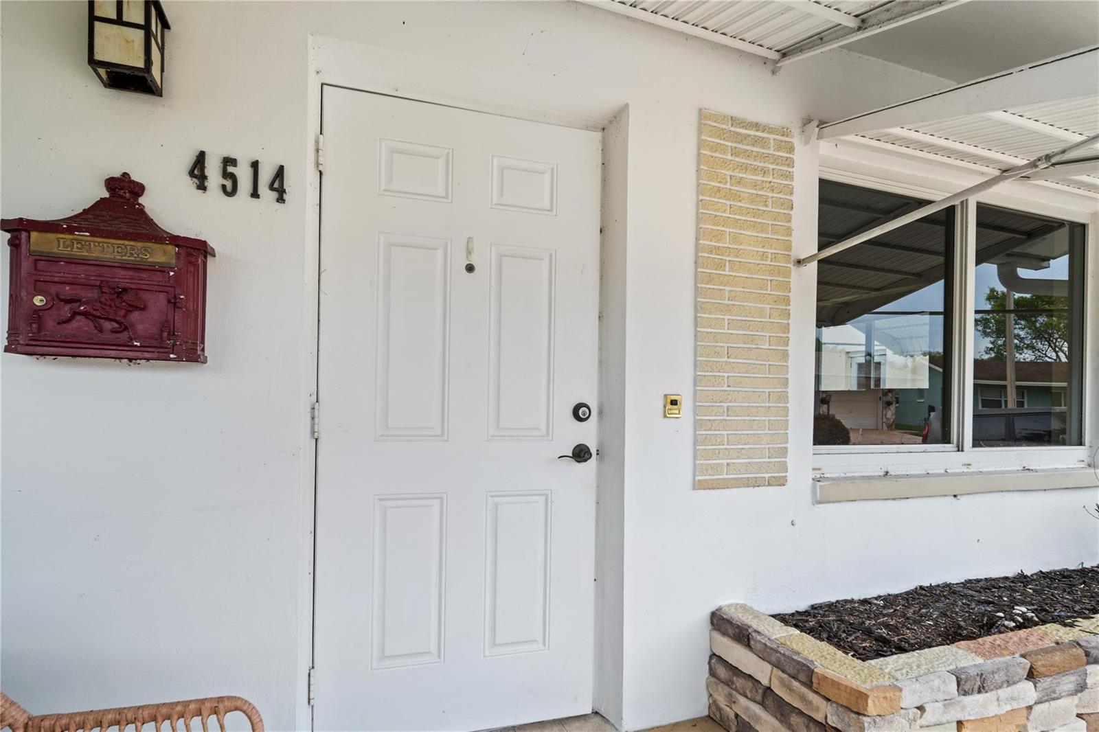 A white front door with a red mailbox and house numbers on a stucco wall — 4514 NW 49th Drive, Tamarac FL 33319, TAMARAC, FL