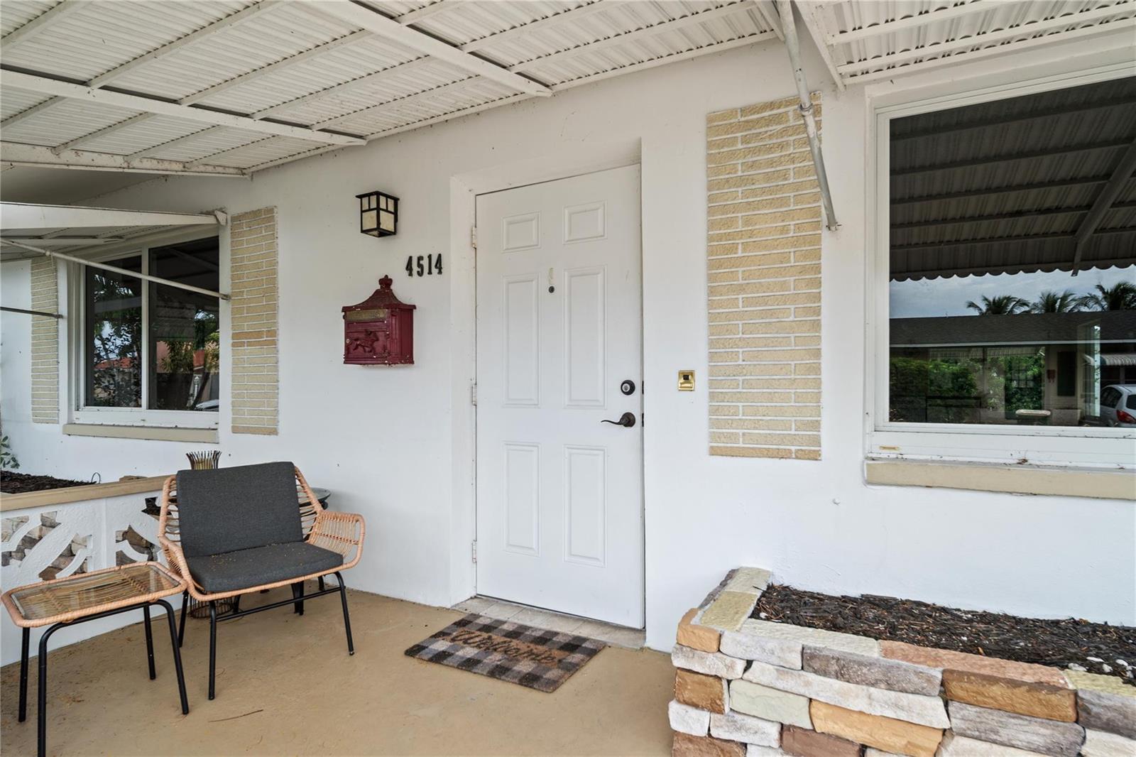 A white house exterior features a front door, a red mailbox, and a small porch — 4514 NW 49th Drive, Tamarac FL 33319, TAMARAC, FL