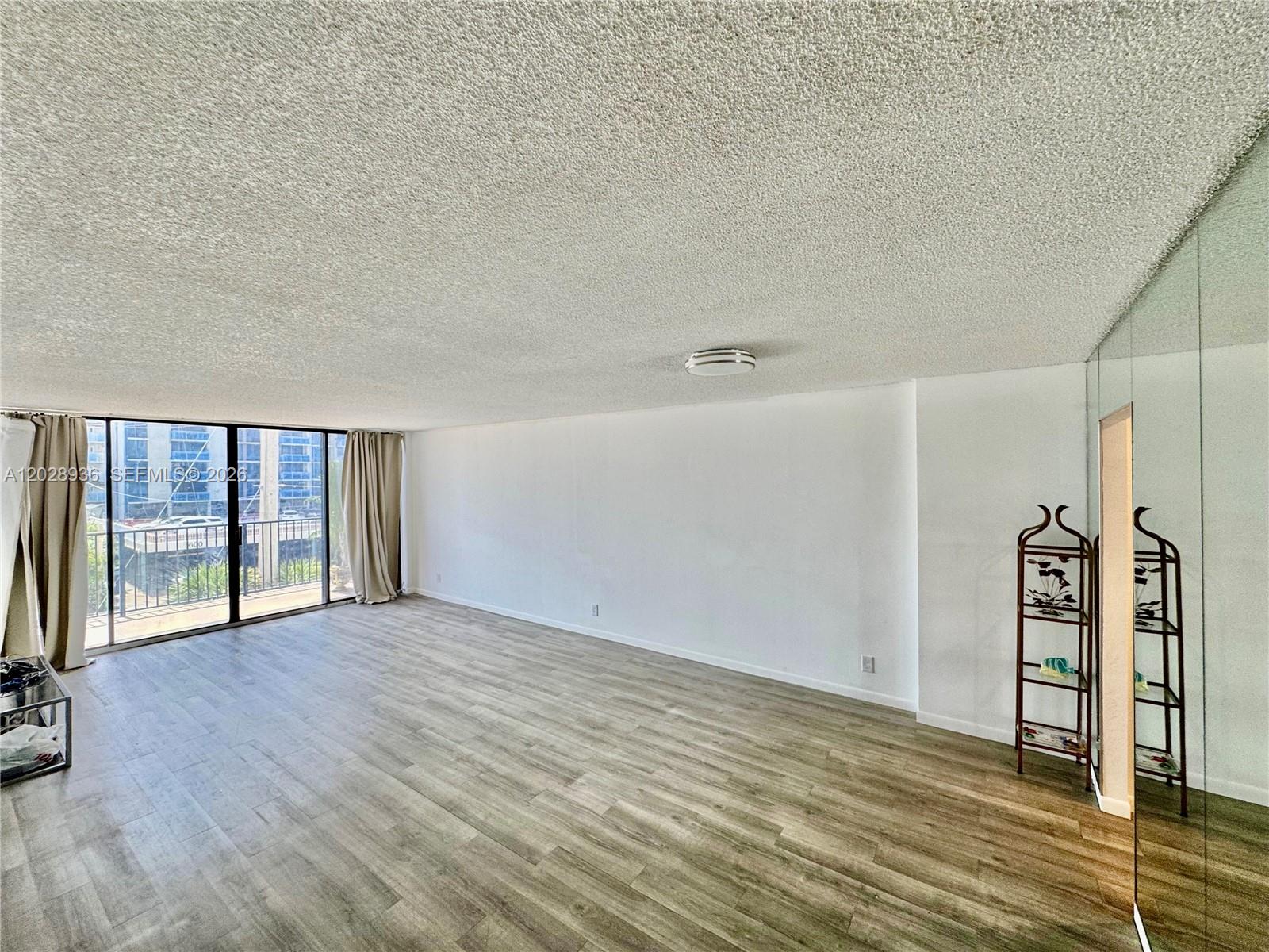 A kitchen features white wood-grain cabinets, a green countertop and backsplash, and stainless appliances — 2101 S Ocean Dr # 306, Hollywood FL 33019, HOLLYWOOD, FL