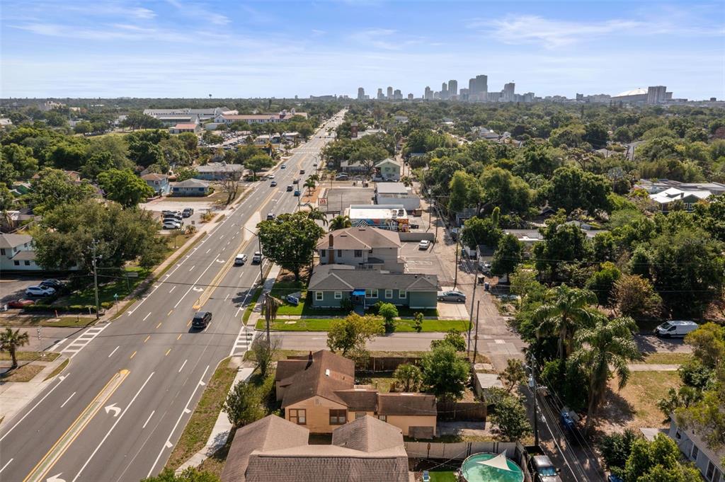 An aerial view shows a multi-lane road leading toward a distant city skyline — 3000 5TH AVENUE N, ST PETERSBURG, FL