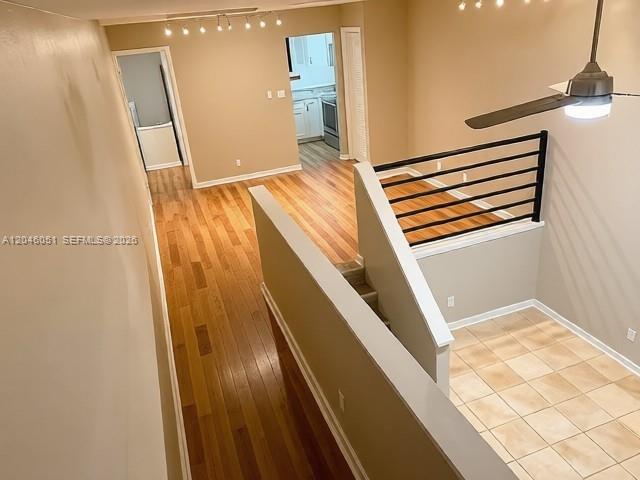 An elevated view shows a split-level interior with hardwood flooring, tiled areas, and a staircase — TALLAHASSEE, FL