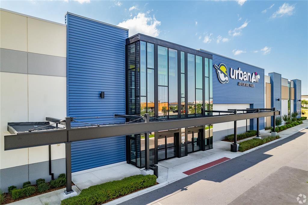 The exterior of an Urban Air Adventure Park building features blue siding and glass windows — 5758 HAMLIN GROVES TRAIL, WINTER GARDEN, FL