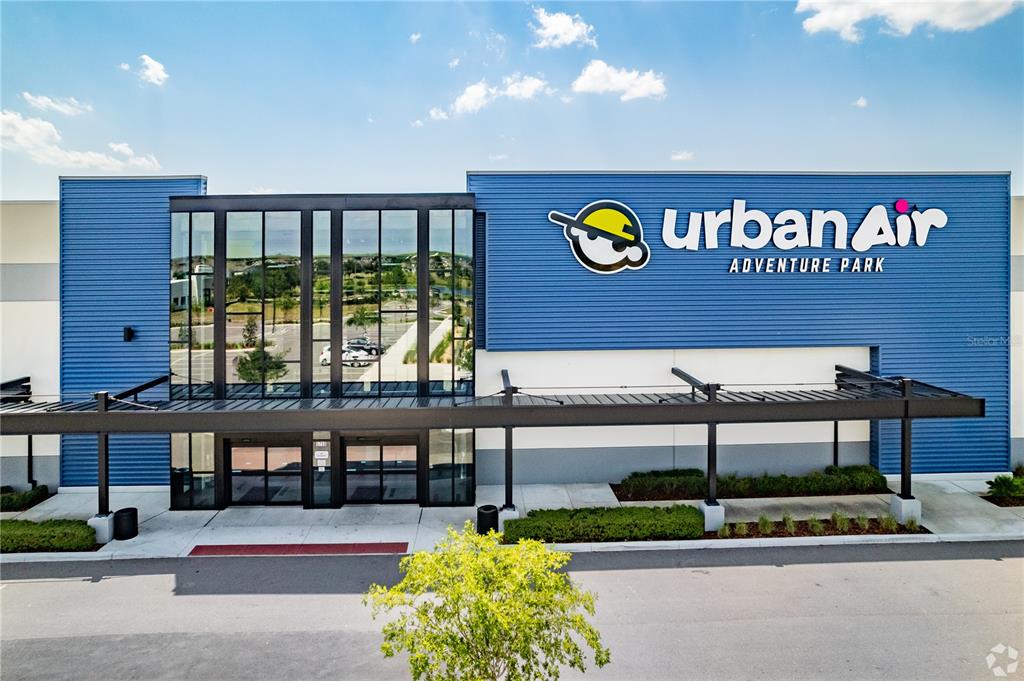 The exterior of an Urban Air Adventure Park building features blue siding and glass windows — 5758 HAMLIN GROVES TRAIL, WINTER GARDEN, FL