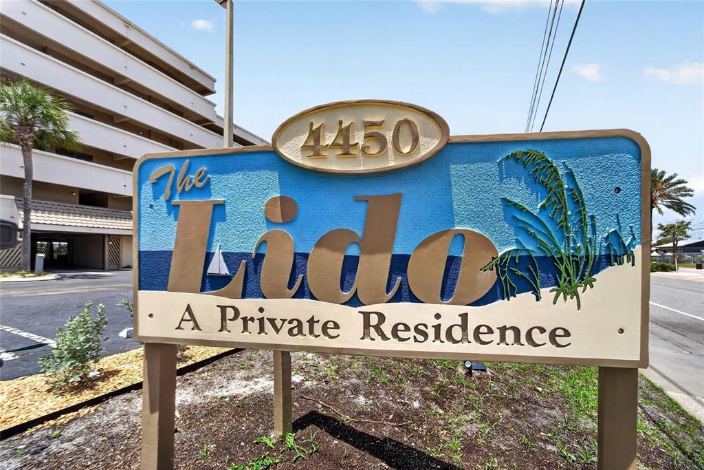 A sign for The Lido private residence stands in front of a multi-story building — 4450 GULF BOULEVARD UNIT 113, ST PETE BEACH, FL