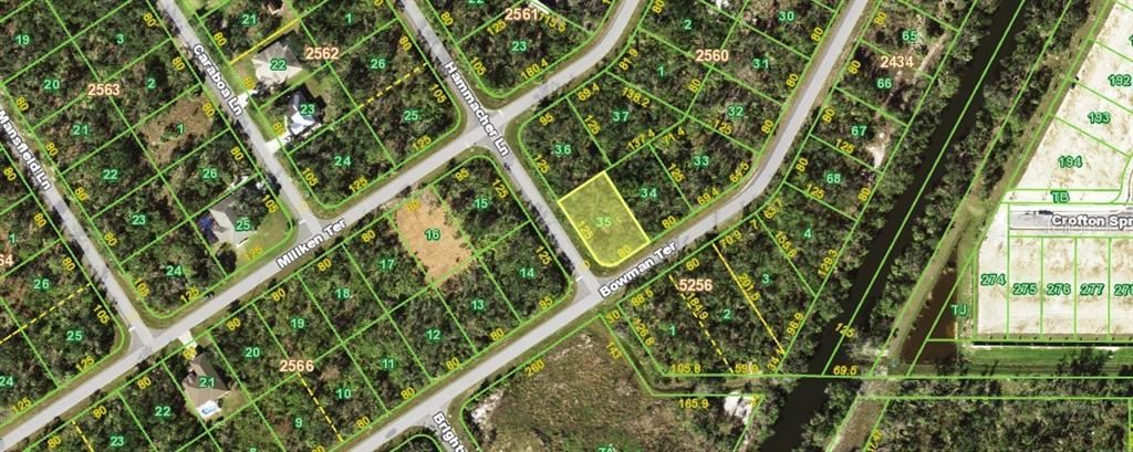 An aerial map showing residential lots, streets, and wooded areas in a suburban neighborhood — 1131 BOWMAN TERRACE, PORT CHARLOTTE, FL