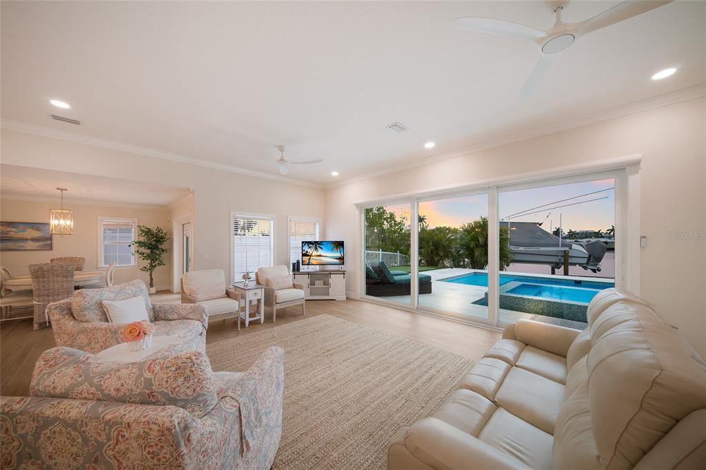 A swimming pool and hot tub sit on a patio beside a house and canal — 532 70TH STREET, HOLMES BEACH, FL