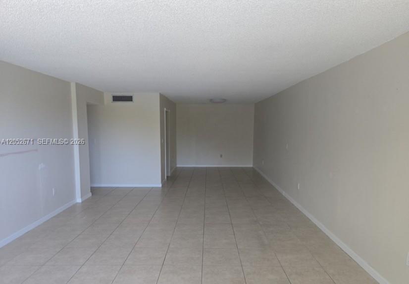 A multi-story apartment building features a central entrance with a green awning and circular driveway — 6861 SW 147th Ave # 3G, Miami FL 33193, MIAMI, FL