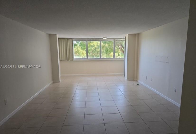 A narrow entryway features beige walls, a tiled floor, and a white front door — 6861 SW 147th Ave # 3G, Miami FL 33193, MIAMI, FL