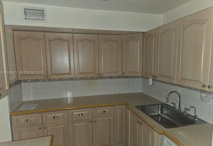 An empty room features light-colored tile flooring, beige walls, and a large window with trees — 6861 SW 147th Ave # 3G, Miami FL 33193, MIAMI, FL