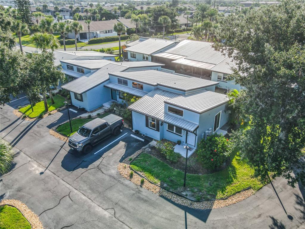 An aerial view shows a light blue house with a metal roof and a truck — 85 HEATHER POINT COURT UNIT 850, NEW SMYRNA BEACH, FL
