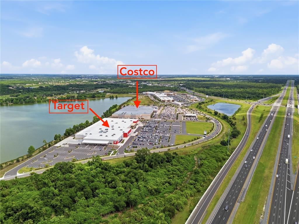 This aerial view shows a Target and a Costco store located near a highway — 335 CAPE HARBOUR LOOP UNIT 108, BRADENTON, FL