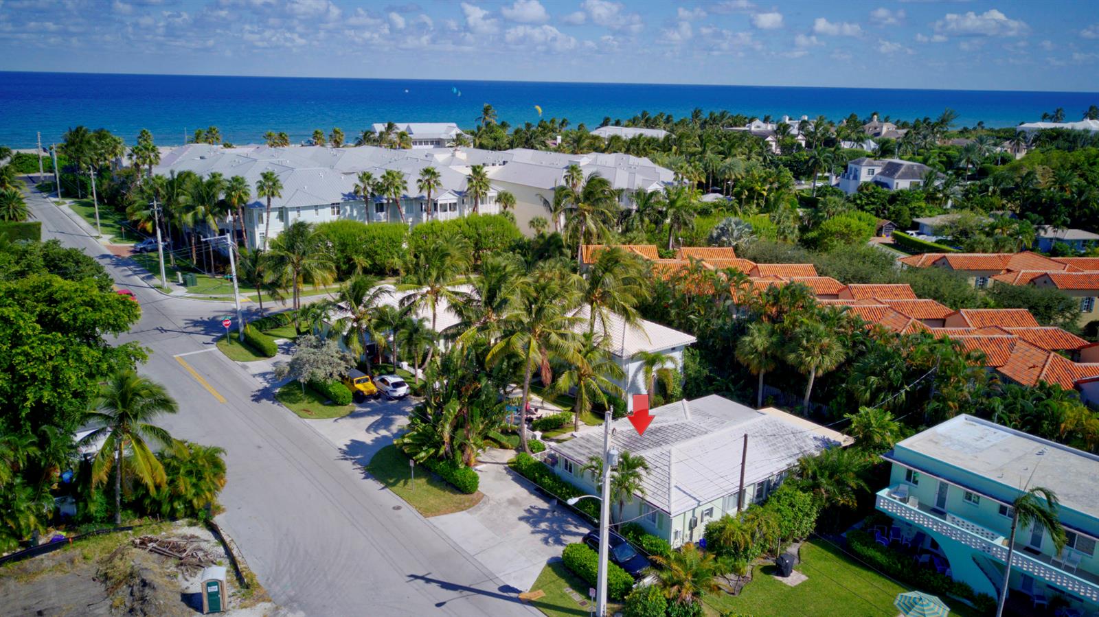 An aerial view shows a residential neighborhood with a light-colored house marked by a red arrow — 1020 Casuarina Road, Delray Beach FL 33483, DELRAY BEACH, FL