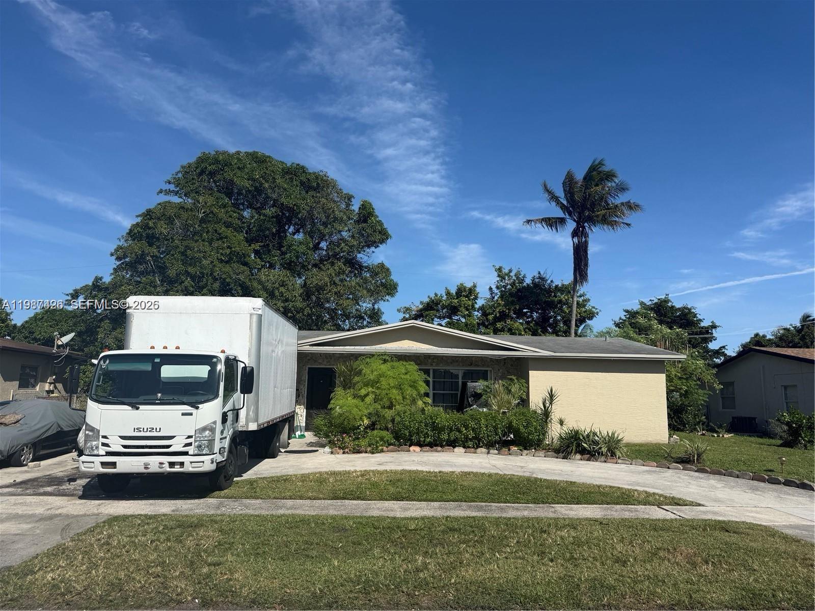 A white box truck is parked in the driveway of a single-story house with landscaping — 4741 NW 18th St, Lauderhill FL 33313, LAUDERHILL, FL