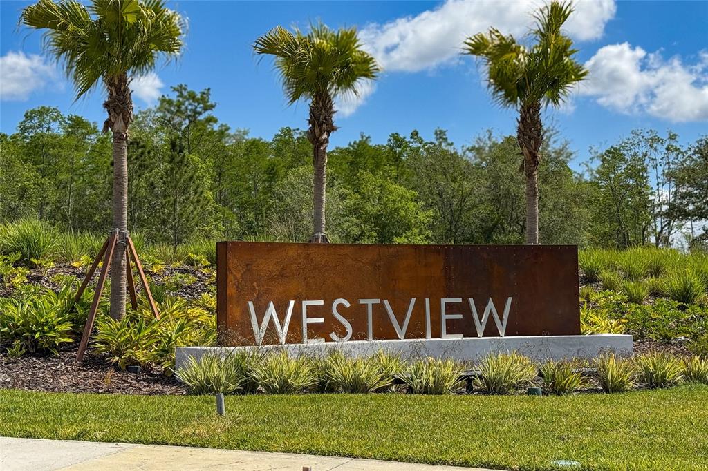 A rusted metal sign reading Westview sits in front of three palm trees and landscaping — 5625 LE MARIN WAY, KISSIMMEE, FL