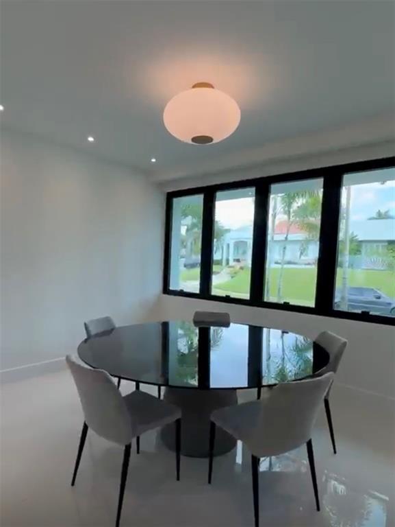 A dining room features a round black table, four grey chairs, and a globe pendant light — D1 SUN VALLEY, GUAYNABO, PR