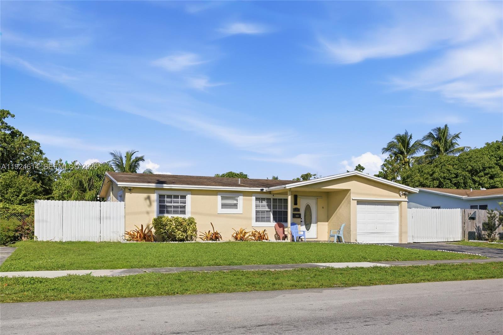 A single-story yellow house with a white garage and a white fence — 2211 NW 46th Ave, Lauderhill FL 33313, LAUDERHILL, FL