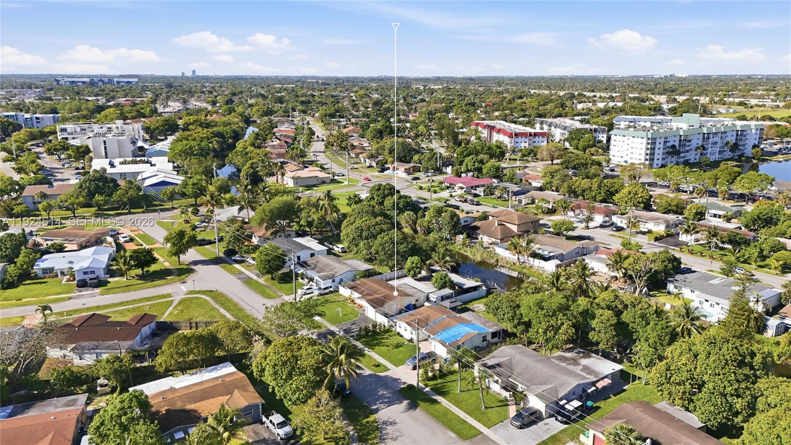 An aerial view shows a residential neighborhood with houses, streets, trees, and a small canal — 2211 NW 46th Ave, Lauderhill FL 33313, LAUDERHILL, FL
