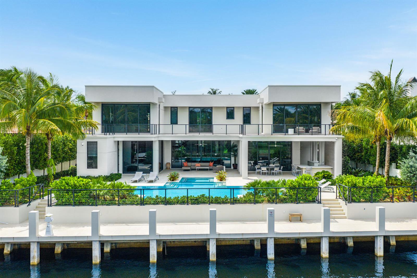 An aerial view of a modern two-story waterfront home with a pool and private dock — 175 W Alexander Palm Road, Boca Raton FL 33432, BOCA RATON, FL