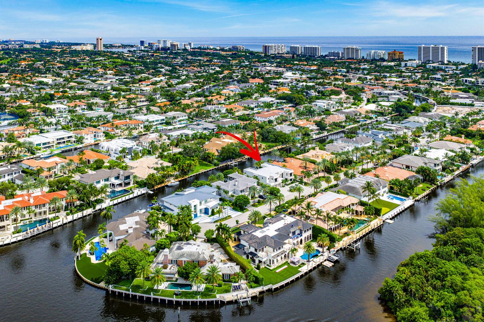 An aerial view shows luxury waterfront homes along a canal in a residential neighborhood — 175 W Alexander Palm Road, Boca Raton FL 33432, BOCA RATON, FL