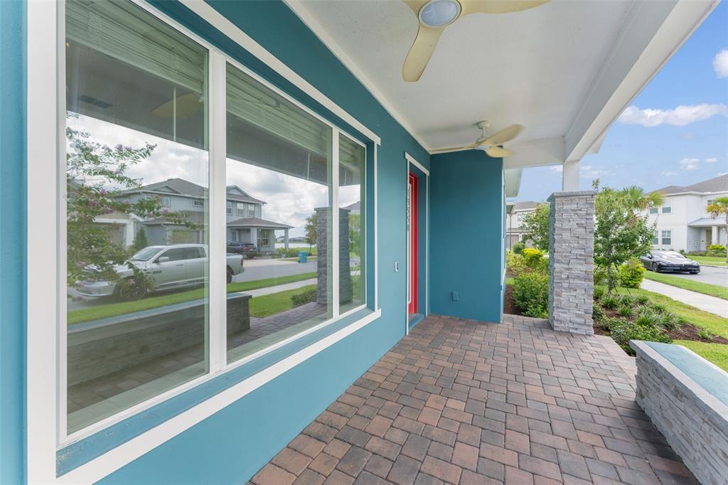 A kitchen features a blue island, white upper cabinets, stainless steel appliances, and tile flooring — 13550 MCMILLAN DRIVE, ORLANDO, FL