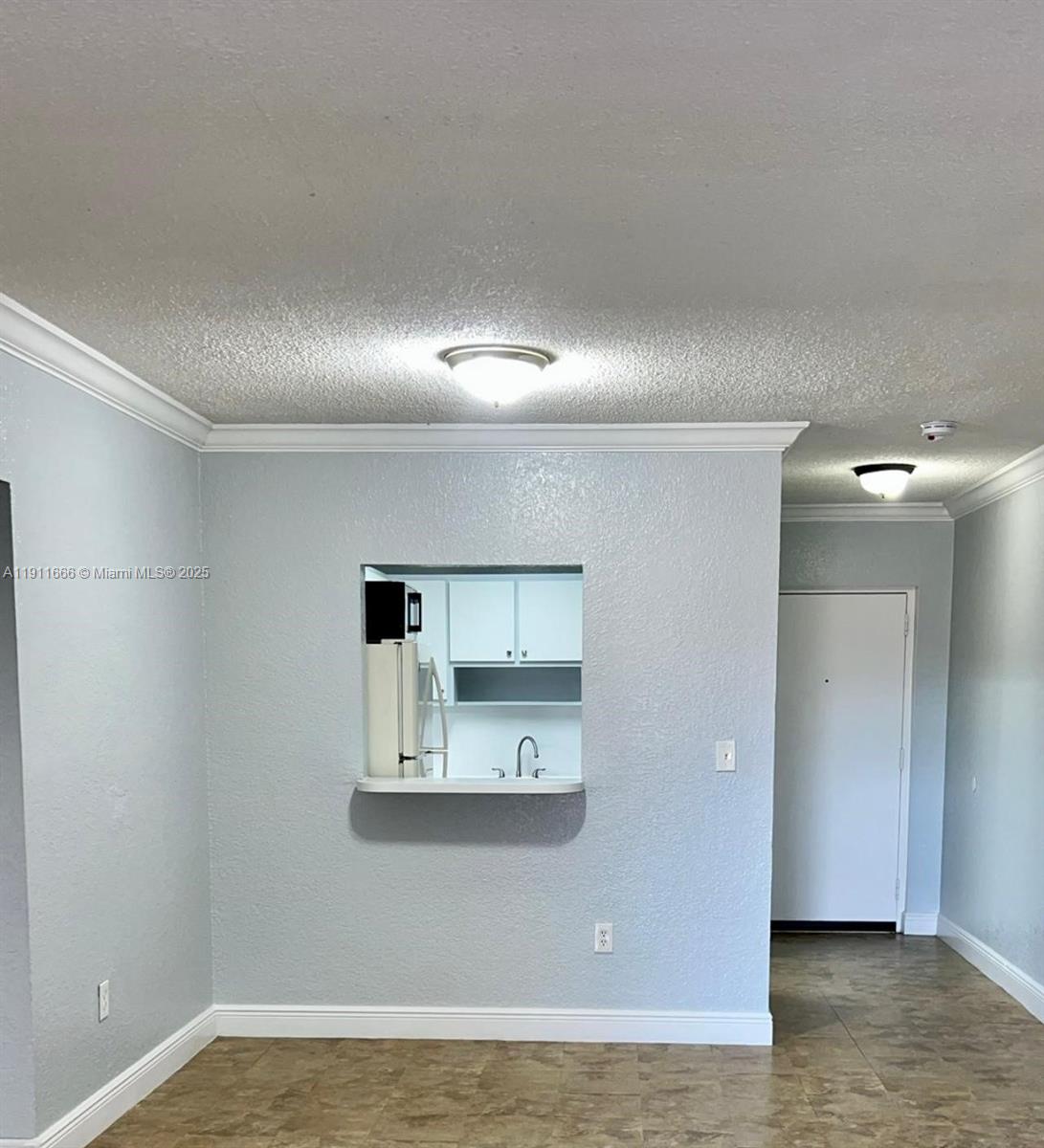 A room with light blue walls, a kitchen pass-through window, and tile flooring — 575 W 69th St # 208, Hialeah FL 33014, HIALEAH, FL