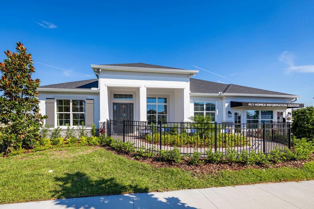 A single-story house with a white facade, dark roof, and a black metal front fence — 2739 RAVENCLIFFE TERRACE, OVIEDO, FL