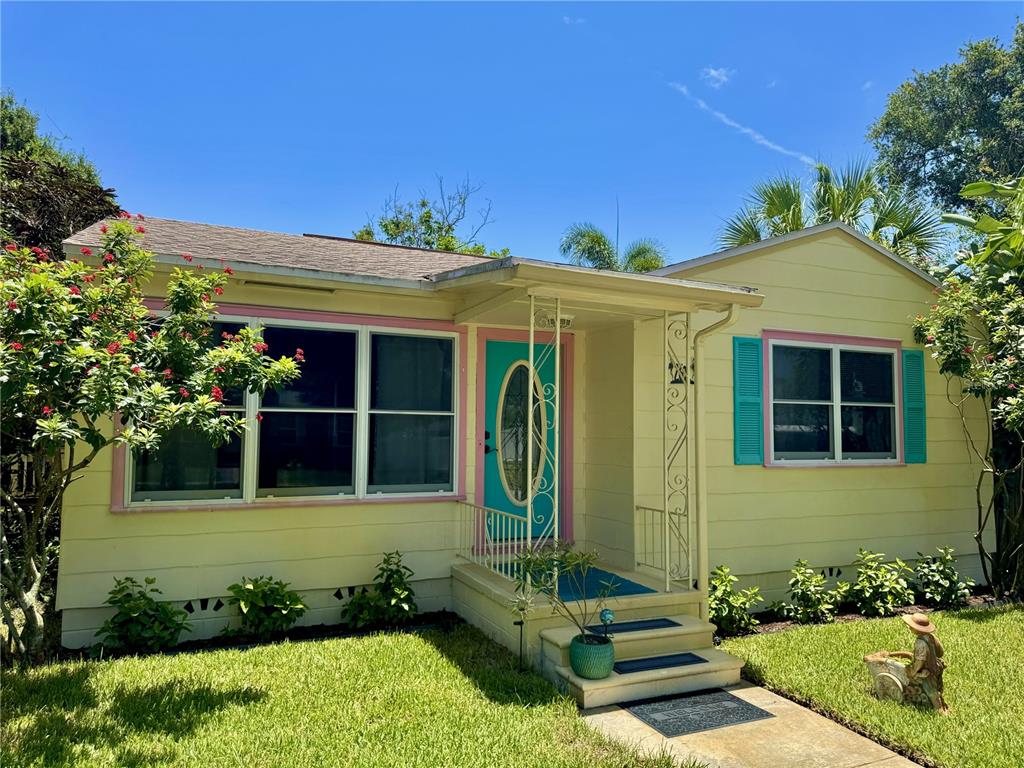 A yellow single-story house with a turquoise front door and matching window shutters — 2602 UPTON STREET S, GULFPORT, FL