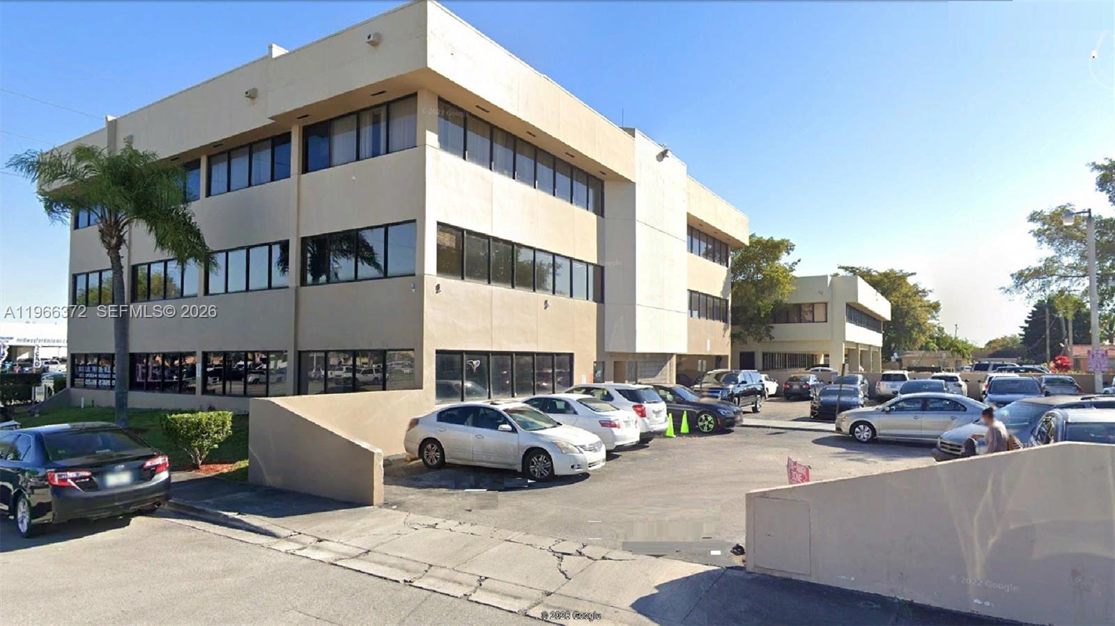 A three-story commercial office building with a parking lot in front — 8080 W Flagler St, Miami FL 33144, MIAMI, FL