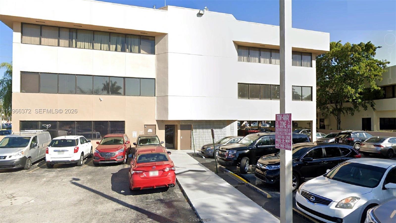 A three-story commercial building with a parking lot in front — 8080 W Flagler St, Miami FL 33144, MIAMI, FL