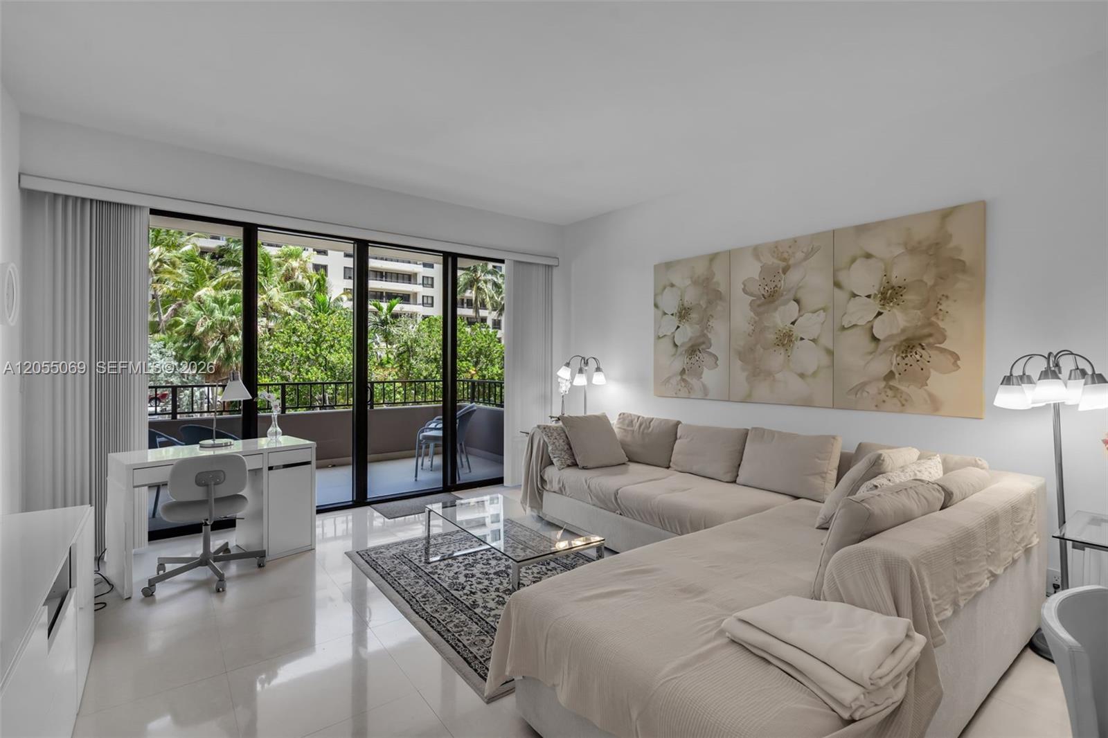 A living room features a beige sectional sofa, a glass coffee table, and a desk — 201 Crandon Blvd # 220, Key Biscayne FL 33149, KEY BISCAYNE, FL