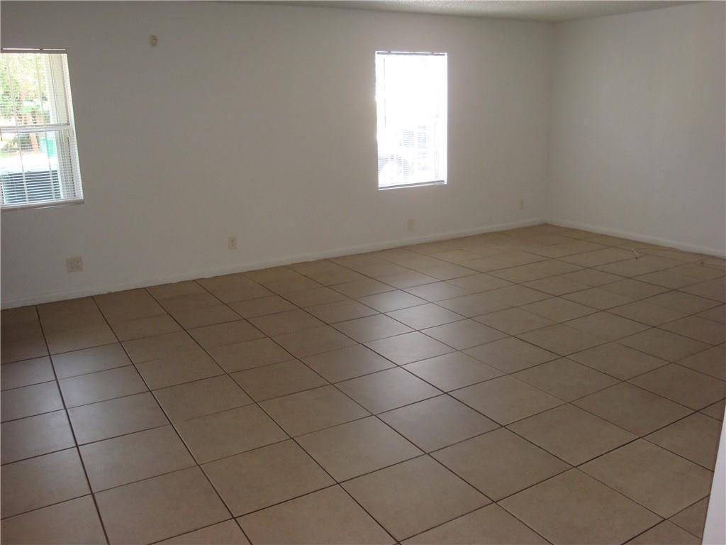 An empty room features white walls and light-colored square floor tiles — 1633 W 28th Street # B, Riviera Beach FL 33404, RIVIERA BEACH, FL