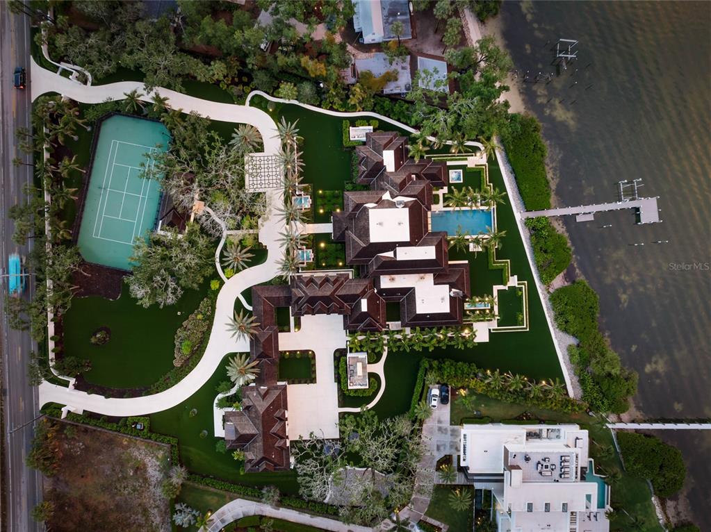 An aerial view of a waterfront estate featuring a tennis court, swimming pool, and dock — 8501 MIDNIGHT PASS ROAD, SARASOTA, FL