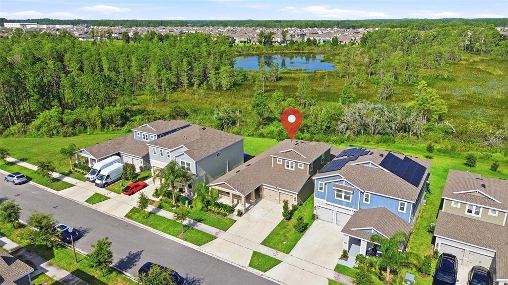 An aerial view shows a suburban neighborhood with houses, a pond, and a red location pin — 16448 PARABLE WAY, WINTER GARDEN, FL