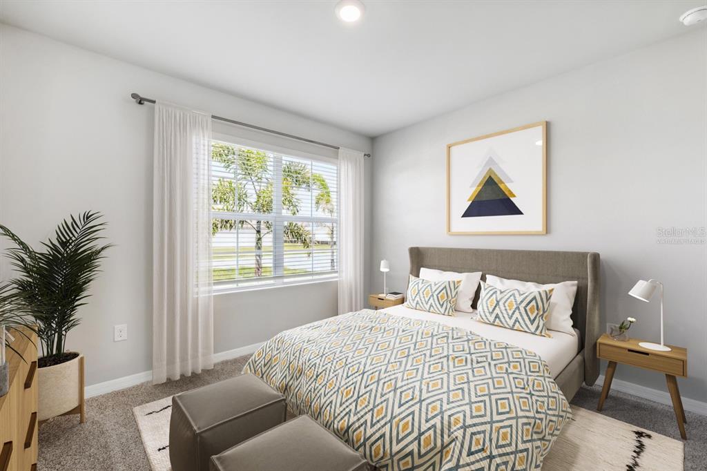 A bedroom features a bed with patterned bedding, two nightstands, and a window with curtains — 26233 CORAL LAKES DRIVE, PUNTA GORDA, FL