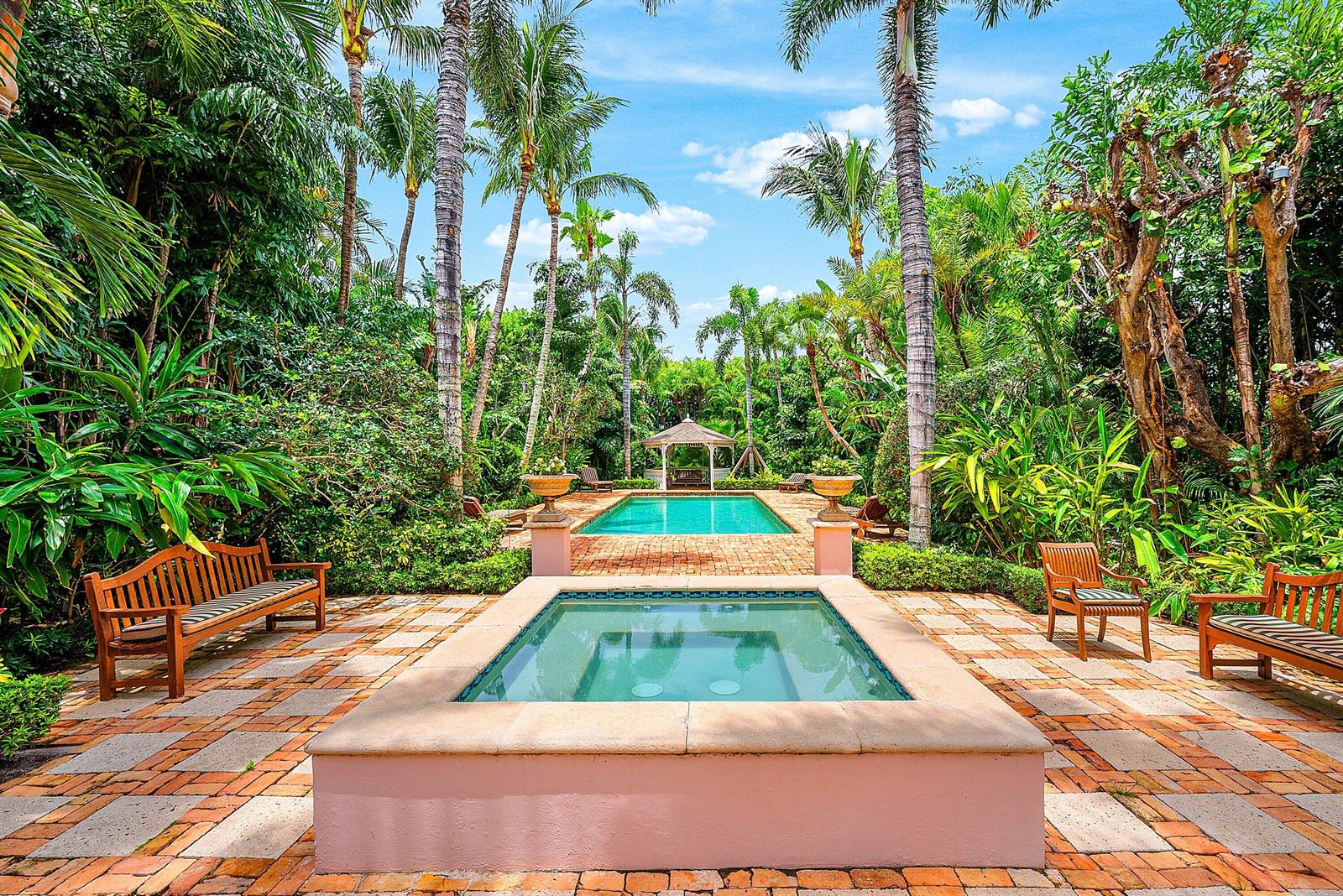 A rectangular swimming pool and a raised hot tub sit on a brick patio outdoors — 406 N Ocean Boulevard, Delray Beach FL 33483, DELRAY BEACH, FL
