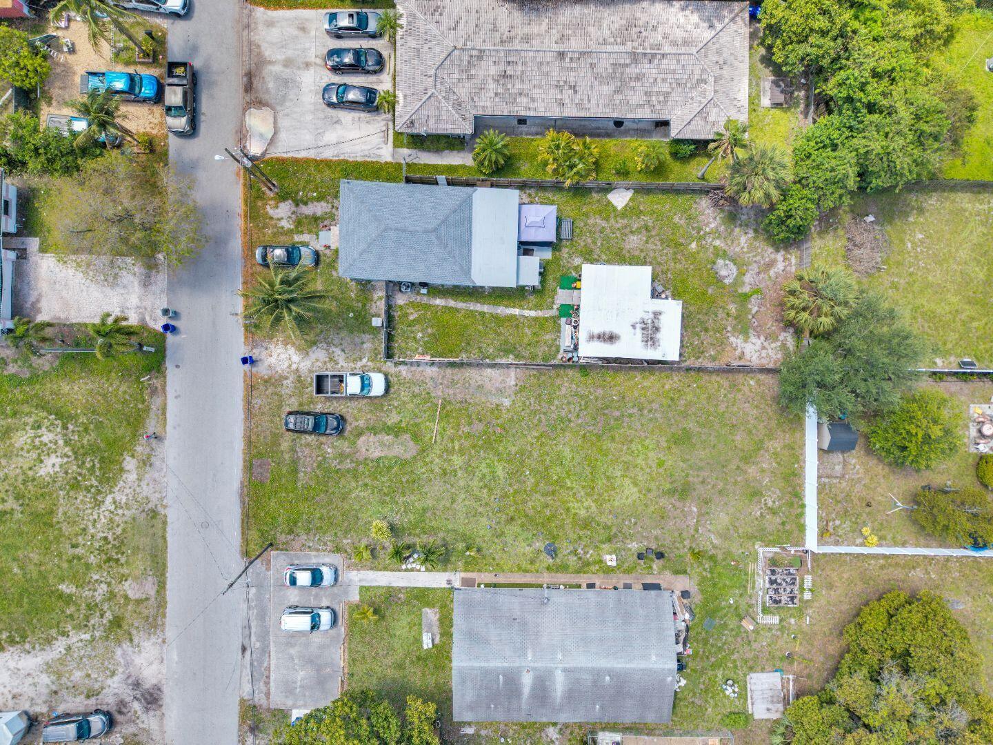An aerial view shows two residential properties with driveways, lawns, and detached structures — 625 NW 15th Avenue, Pompano Beach FL 33069, POMPANO BEACH, FL