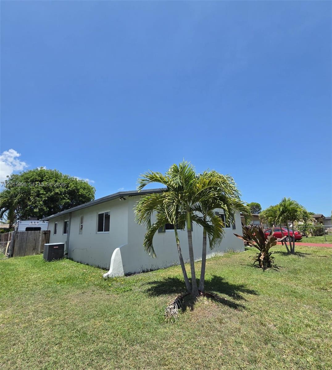 A single-story house with a white exterior and palm trees in the front yard — 11941 SW 200th St, Miami FL 33177, MIAMI, FL