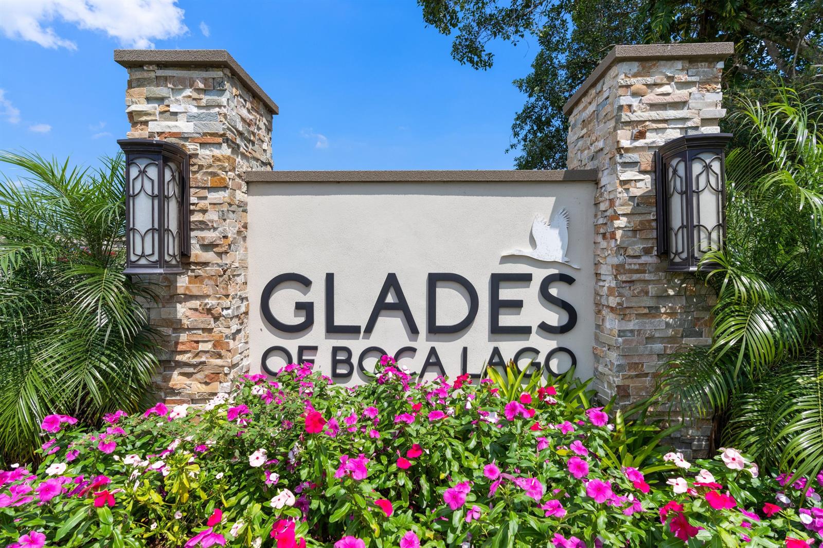A stone-pillared monument sign for Glades of Boca Lago sits behind a bed of flowers — 21734 Arriba Real # 32b, Boca Raton FL 33433, BOCA RATON, FL