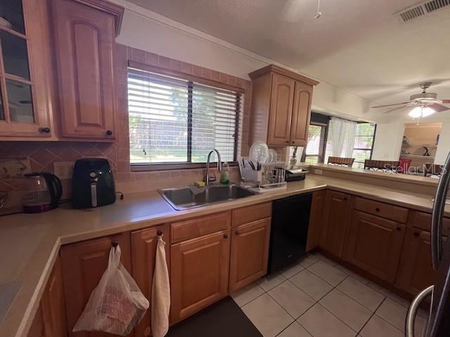 A kitchen features wood cabinets, a double sink, and a window above the counter — 101 GRAND PLAZA DRIVE UNIT I20, ORANGE CITY, FL