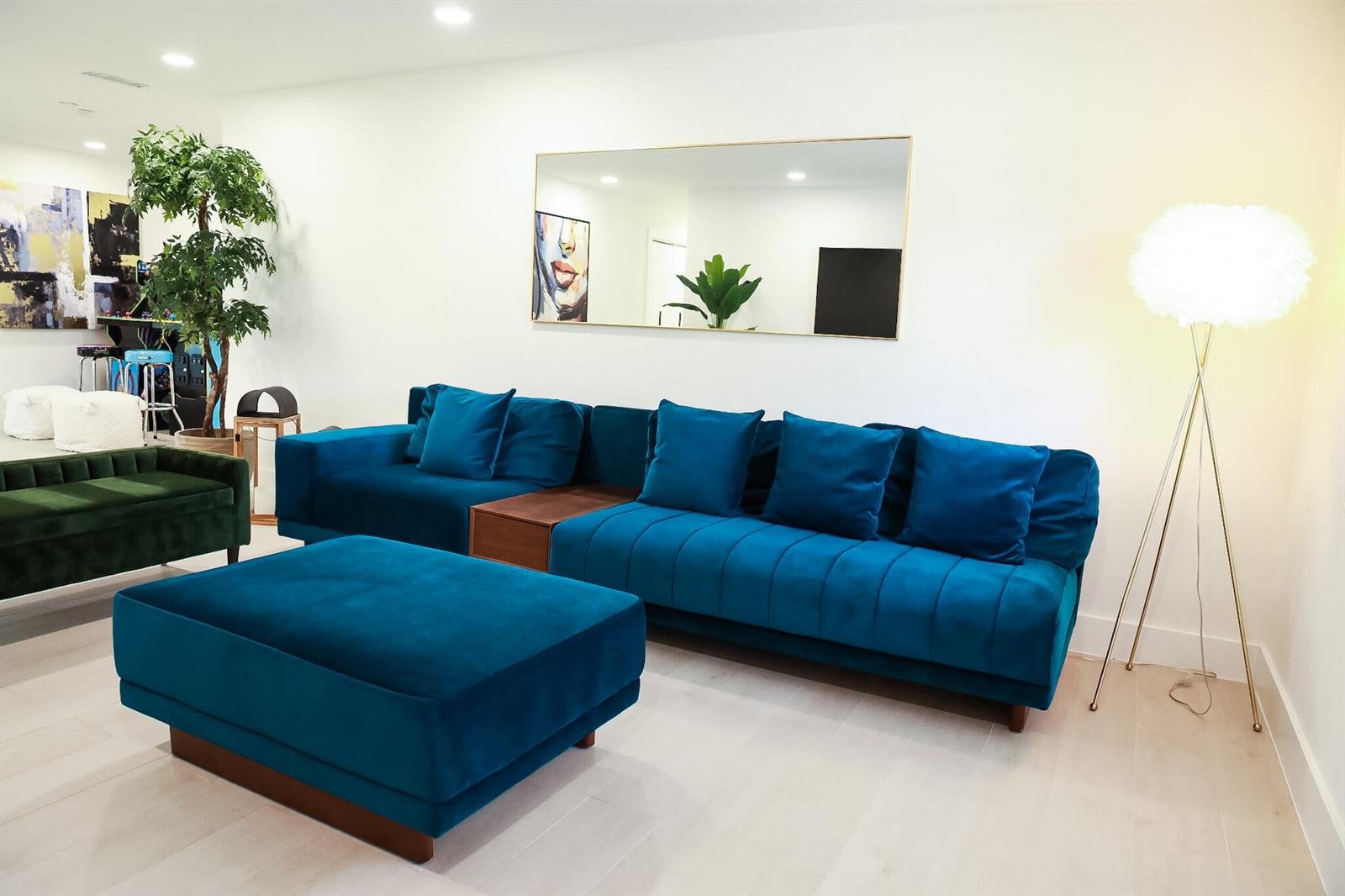 A living room features a blue velvet sectional sofa, a matching ottoman, and a floor lamp — 1502 NW 4th Avenue, Delray Beach FL 33432, DELRAY BEACH, FL