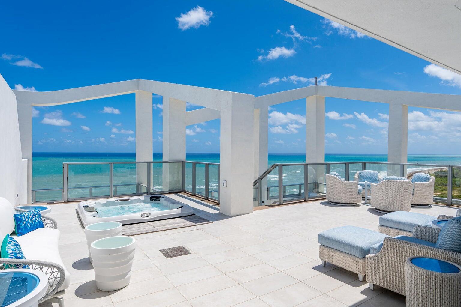 A rooftop terrace features a hot tub, white wicker furniture, and glass railings overlooking the ocean — 3100 N Ocean Drive, Riviera Beach FL 33404, RIVIERA BEACH, FL