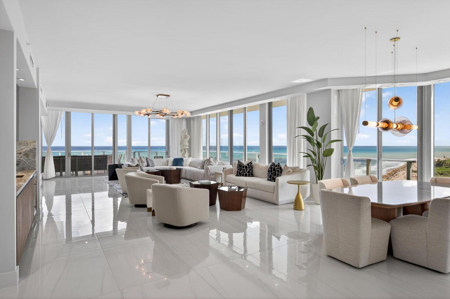 A bright, open-concept living and dining area with floor-to-ceiling windows overlooking the ocean — 3100 N Ocean Drive, Riviera Beach FL 33404, RIVIERA BEACH, FL