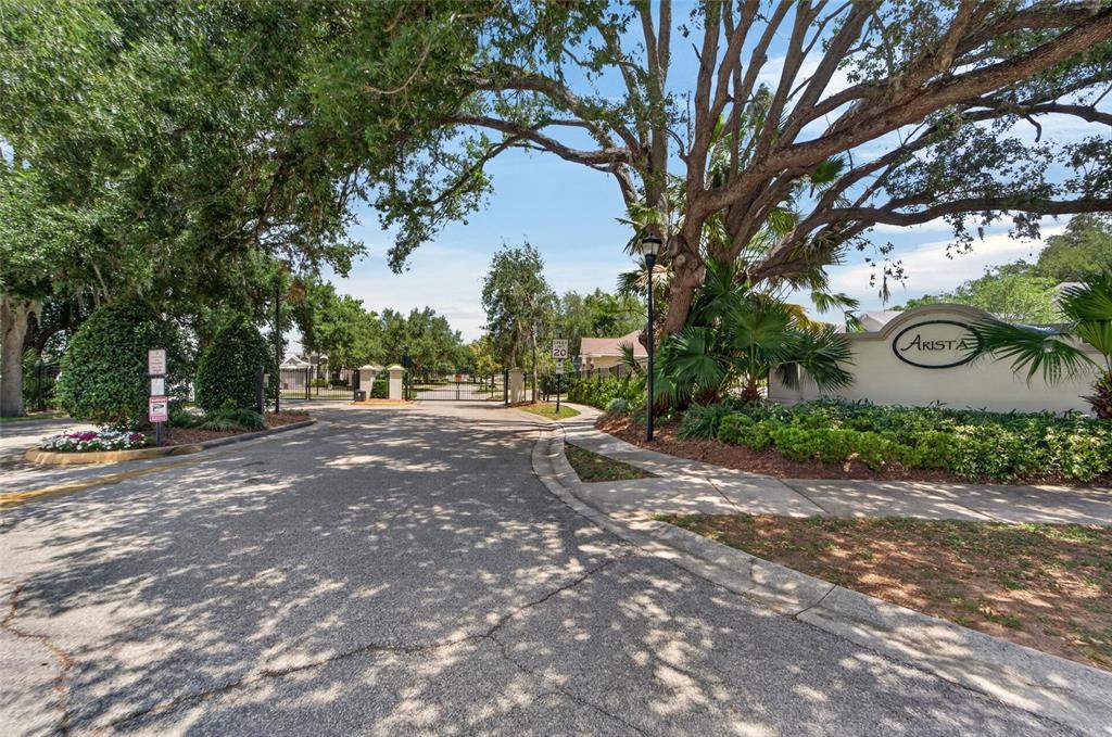 A gated entrance with a sign reading Arista surrounded by trees and landscaping — 2309 SILVER TRUMPET COURT, VALRICO, FL